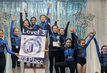 Gymnastic team receiving 3rd place award