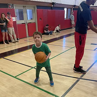 child holding basketball