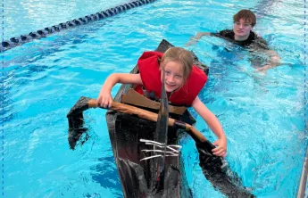 girl in cardboard boat