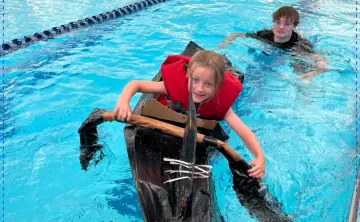 girl in cardboard boat